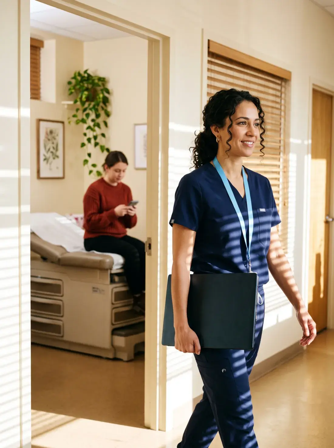 Family doctor walking out of an exam room to her next patient while the patient pays on her phone